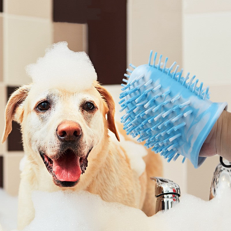 Dog bath time with silicone grooming glove and bubbles in bathroom
