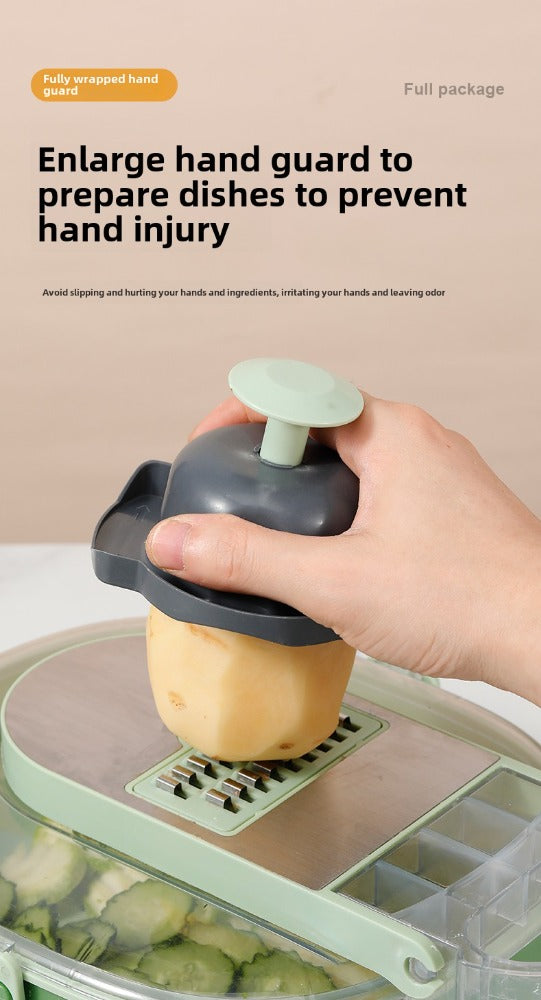 Hand using enlarged guard to safely grate potato on kitchen slicer with vegetable container