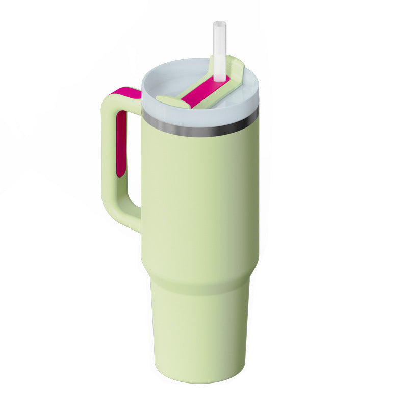 Pale green insulated travel tumbler with handle, lid, straw, and pink accent details