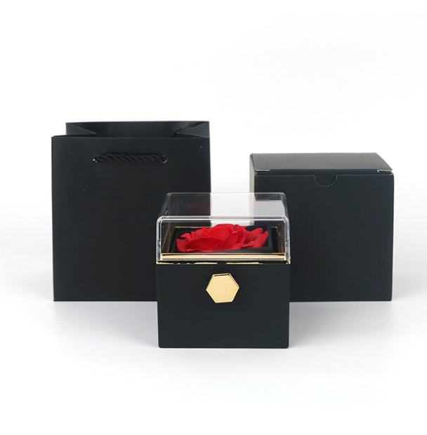 Luxury black gift box with gold accent, clear lid, and preserved red rose, with packaging