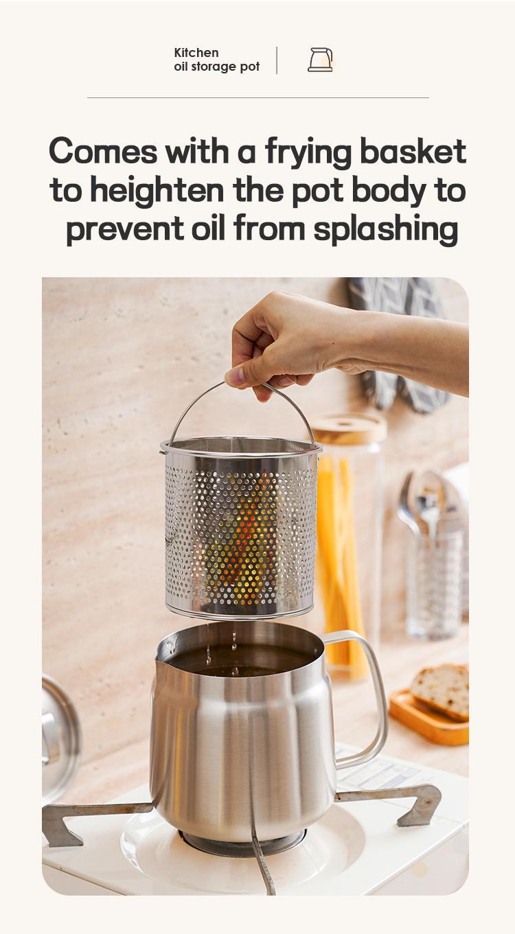 Stainless steel oil storage pot with perforated frying basket being lifted in a kitchen setting