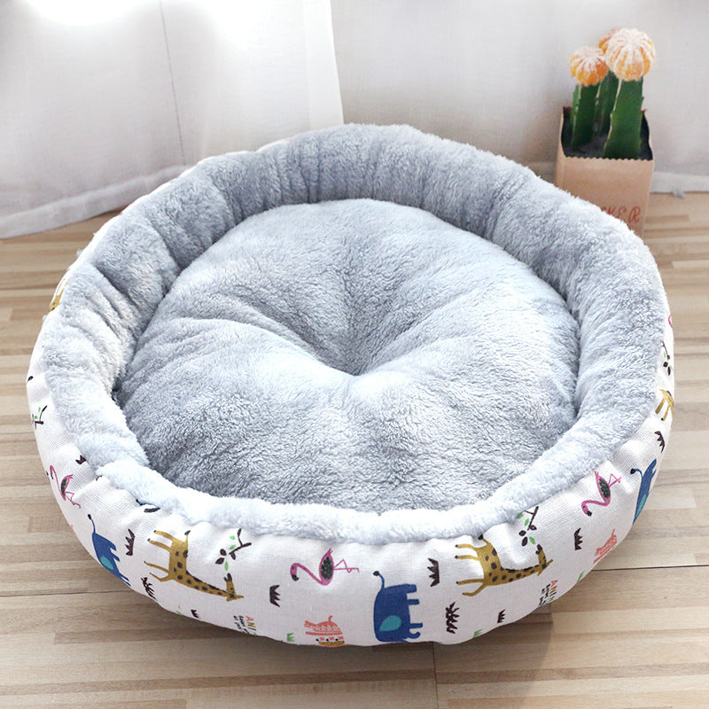 Round plush pet bed with soft grey cushion and colorful animal print sides on wood floor